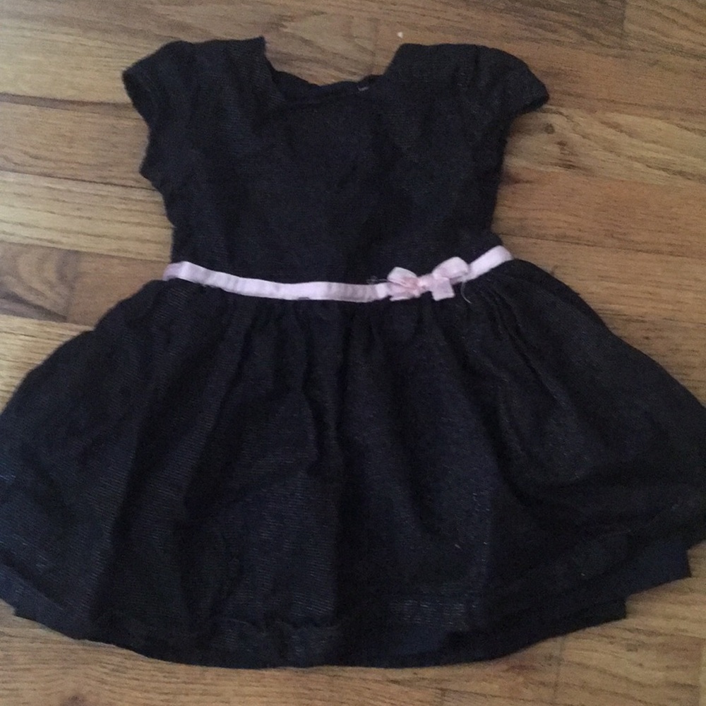 Sparkly black dress with small pink ribbon and bow